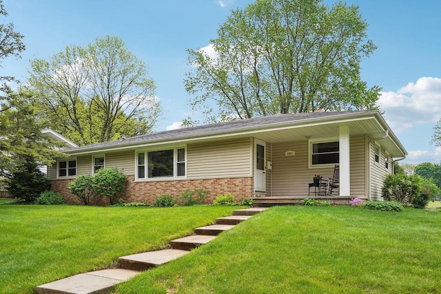 4901 Ralph Cir, Madison, WI 53714 - ranch-style house featuring a front yard, brick siding, and a porch