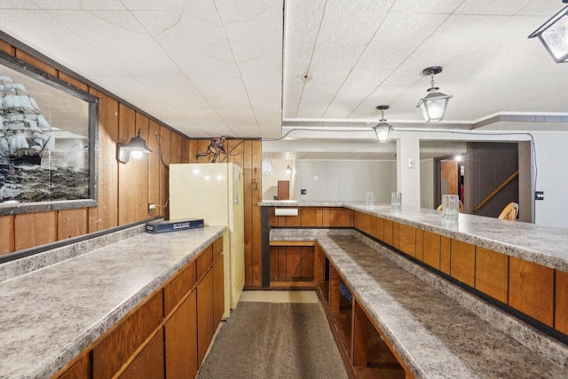 4901 Ralph Cir, Madison, WI 53714 - kitchen featuring brown cabinetry, freestanding refrigerator, light countertops, and hanging light fixtures