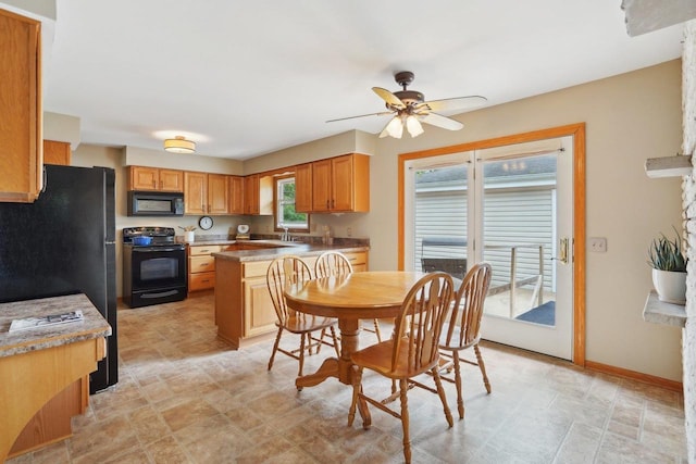 4901 Ralph Cir, Madison, WI 53714 - kitchen with black appliances, stone finish flooring, a ceiling fan, a sink, and light countertops