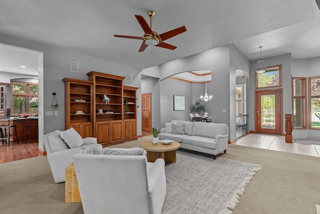 441 E Apple Creek Rd, Appleton, WI 54913 - living room with arched walkways, light colored carpet, ceiling fan, baseboards, and lofted ceiling