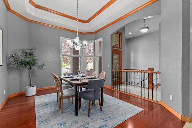 441 E Apple Creek Rd, Appleton, WI 54913 - dining space featuring a textured wall, hardwood / wood-style floors, arched walkways, a chandelier, and baseboards