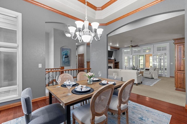 441 E Apple Creek Rd, Appleton, WI 54913 - dining area with arched walkways, a ceiling fan, a textured wall, a chandelier, and a tray ceiling