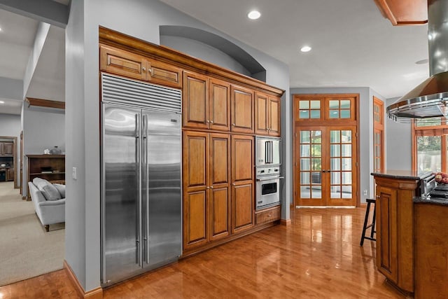 441 E Apple Creek Rd, Appleton, WI 54913 - kitchen with stainless steel built in fridge, brown cabinets, light wood-style floors, french doors, and recessed lighting