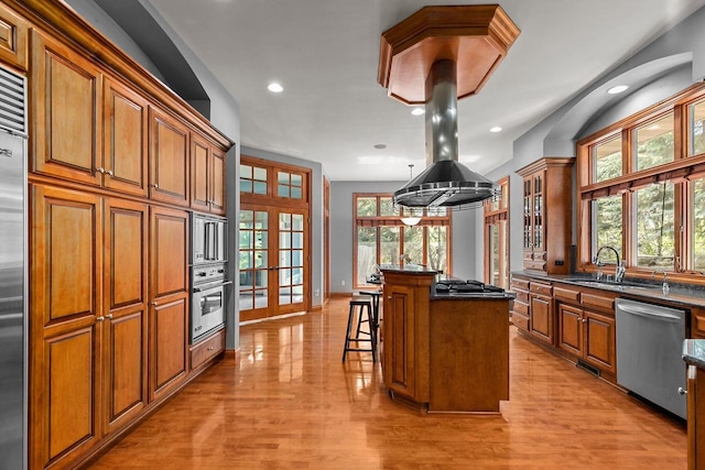 441 E Apple Creek Rd, Appleton, WI 54913 - kitchen featuring stainless steel appliances, a sink, brown cabinets, a center island, and a breakfast bar