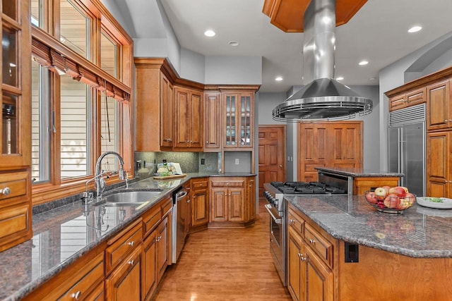 441 E Apple Creek Rd, Appleton, WI 54913 - kitchen with high end appliances, a sink, a center island, brown cabinets, and recessed lighting