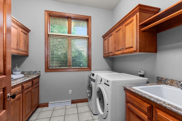 441 E Apple Creek Rd, Appleton, WI 54913 - washroom featuring cabinet space, washer and clothes dryer, baseboards, and light tile patterned floors