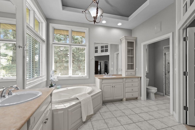 441 E Apple Creek Rd, Appleton, WI 54913 - bathroom with two vanities, a bath, tile patterned flooring, toilet, and a tray ceiling