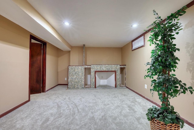 unfurnished living room featuring carpet, recessed lighting, and baseboards