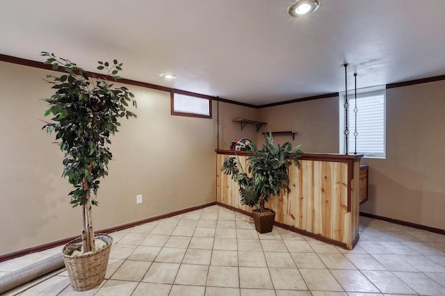 basement featuring ornamental molding, baseboards, and recessed lighting