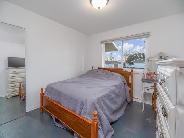 512 Conrad Ln, Beaver Dam, WI 53916 - bedroom featuring wood finished floors, a baseboard heating unit, and baseboards