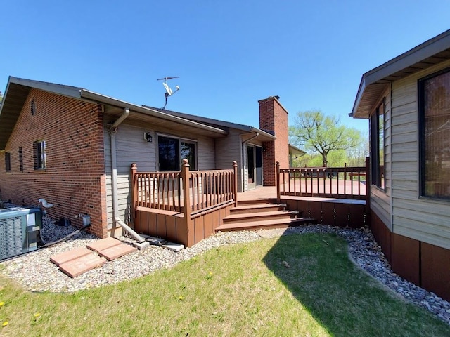 171 8th St, Clintonville, WI 54929 - rear view of house featuring a wooden deck, a chimney, a yard, and cooling unit