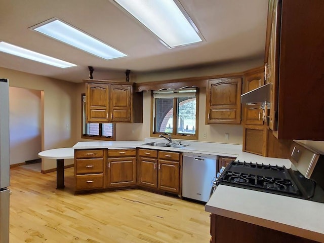 171 8th St, Clintonville, WI 54929 - kitchen with dishwasher, black gas range oven, a sink, brown cabinets, and light countertops