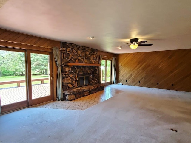 171 8th St, Clintonville, WI 54929 - unfurnished living room with wooden walls, carpet flooring, a fireplace, and ceiling fan