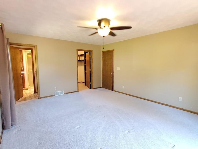 171 8th St, Clintonville, WI 54929 - unfurnished bedroom featuring a walk in closet, baseboards, light colored carpet, and ensuite bath