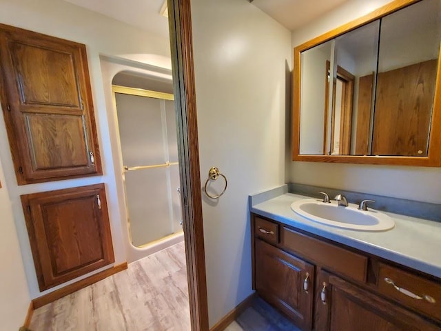 171 8th St, Clintonville, WI 54929 - bathroom featuring a shower stall, vanity, baseboards, and wood finished floors