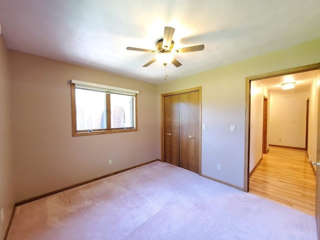171 8th St, Clintonville, WI 54929 - unfurnished bedroom featuring a closet, light colored carpet, baseboards, and ceiling fan