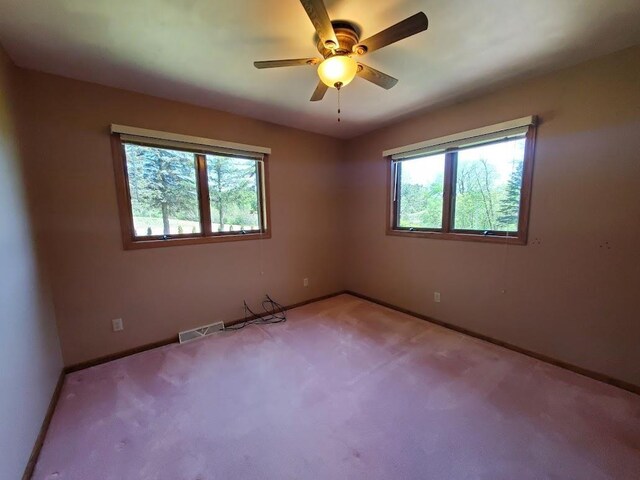 171 8th St, Clintonville, WI 54929 - carpeted empty room with plenty of natural light, baseboards, and ceiling fan