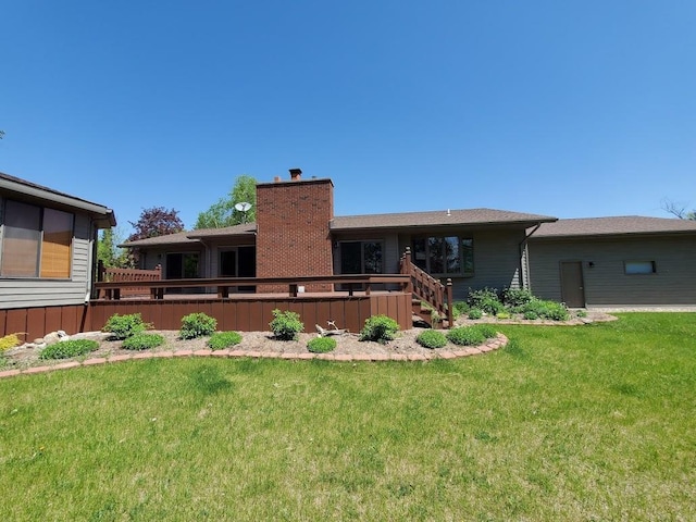 171 8th St, Clintonville, WI 54929 - rear view of house with a lawn, a deck, and a chimney