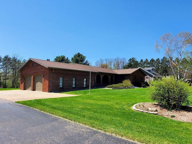 171 8th St, Clintonville, WI 54929 - single story home with a front lawn, brick siding, a garage, and concrete driveway