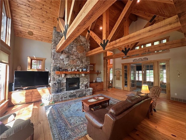 W735 County Road D, Birchwood, WI 54817 - living room featuring high vaulted ceiling, a fireplace, hardwood / wood-style floors, beam ceiling, and baseboards