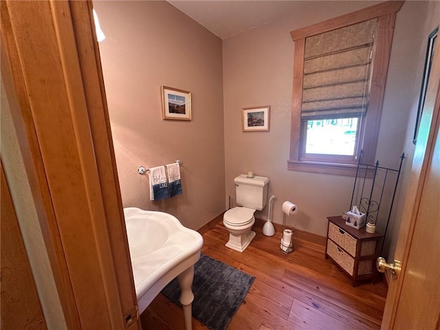 W735 County Road D, Birchwood, WI 54817 - bathroom featuring baseboards, wood finished floors, and toilet
