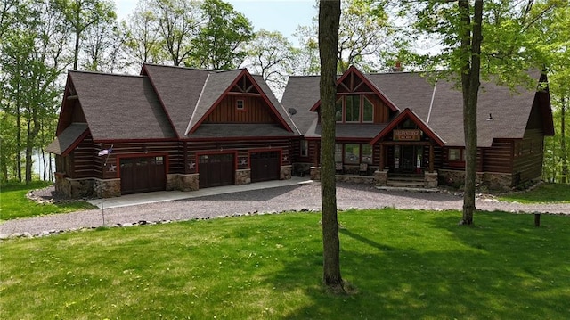 W735 County Road D, Birchwood, WI 54817 - log cabin featuring gravel driveway, a front lawn, stone siding, and a garage
