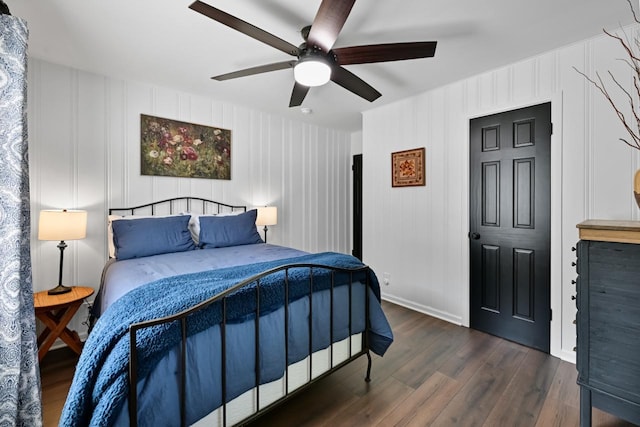 bedroom featuring dark wood-type flooring, a ceiling fan, and baseboards