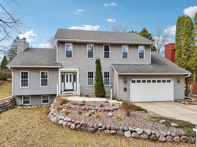 1714 Lewon Dr, Madison, WI 53711 - colonial home featuring a chimney, driveway, a front lawn, and a shingled roof