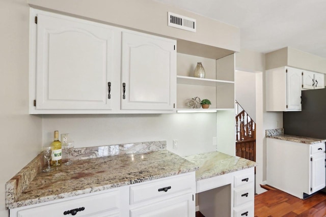 1714 Lewon Dr, Madison, WI 53711 - kitchen featuring light stone counters, white cabinetry, dark wood-style flooring, and open shelves