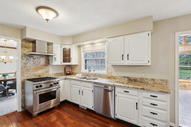 1714 Lewon Dr, Madison, WI 53711 - kitchen with appliances with stainless steel finishes, a sink, wall chimney range hood, dark wood-type flooring, and white cabinets