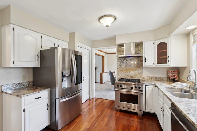 1714 Lewon Dr, Madison, WI 53711 - kitchen featuring wall chimney exhaust hood, stainless steel appliances, a sink, dark wood-style floors, and white cabinetry