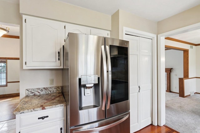 1714 Lewon Dr, Madison, WI 53711 - kitchen featuring stainless steel fridge, white cabinetry, light stone counters, and wood finished floors