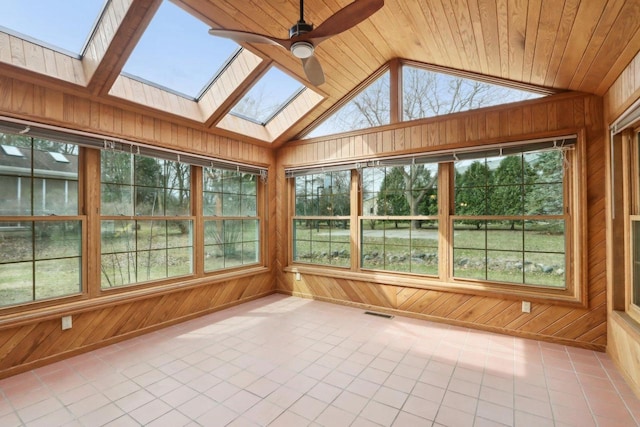 1714 Lewon Dr, Madison, WI 53711 - unfurnished sunroom with a skylight, tile patterned floors, wood walls, and lofted ceiling