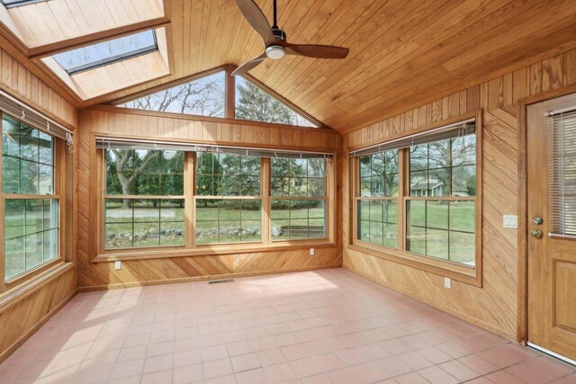 1714 Lewon Dr, Madison, WI 53711 - unfurnished sunroom with wood walls, a skylight, lofted ceiling, healthy amount of natural light, and tile patterned flooring