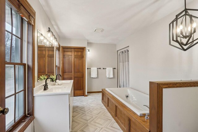1714 Lewon Dr, Madison, WI 53711 - bathroom with a garden tub, double vanity, and baseboards