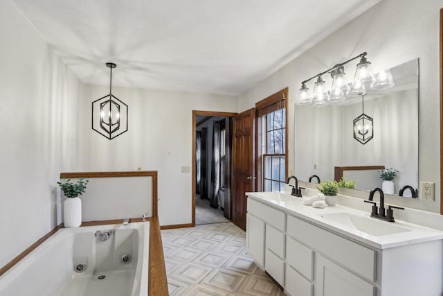 1714 Lewon Dr, Madison, WI 53711 - bathroom with a chandelier, a tub with jets, double vanity, and baseboards