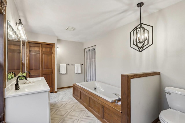 1714 Lewon Dr, Madison, WI 53711 - full bathroom featuring toilet, a bath, a chandelier, and vanity
