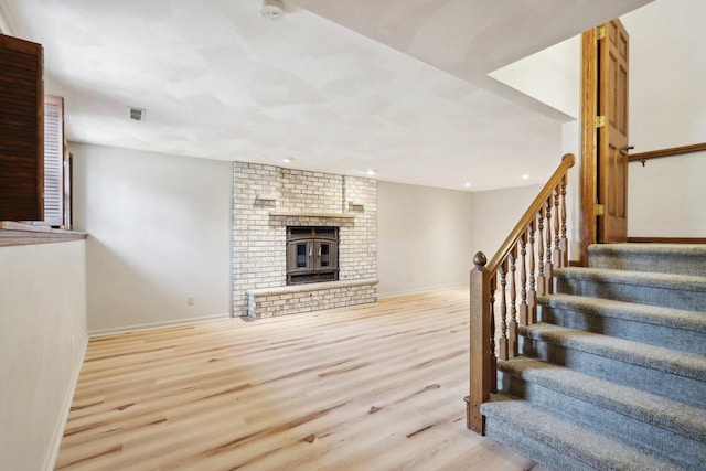 1714 Lewon Dr, Madison, WI 53711 - stairs featuring wood finished floors, recessed lighting, baseboards, and a brick fireplace