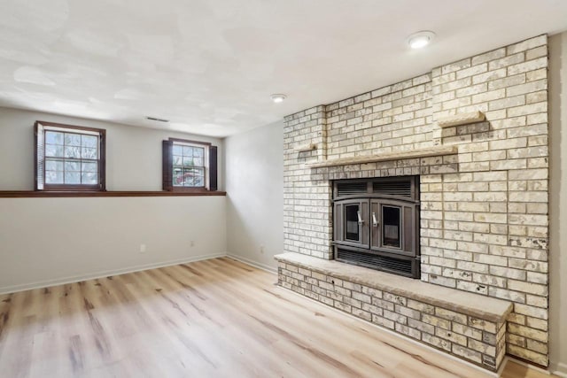 1714 Lewon Dr, Madison, WI 53711 - unfurnished living room with wood finished floors, baseboards, and a brick fireplace