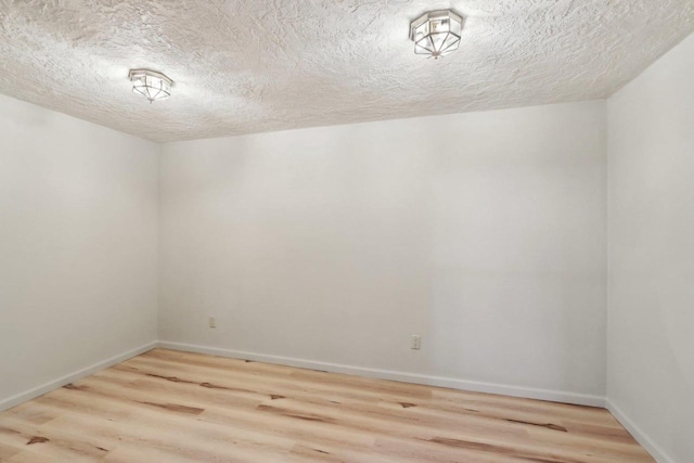 1714 Lewon Dr, Madison, WI 53711 - spare room with wood finished floors, a textured ceiling, and baseboards