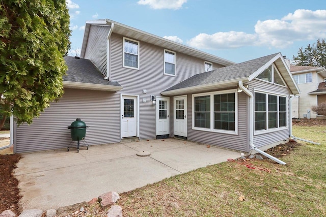 1714 Lewon Dr, Madison, WI 53711 - back of property with a patio area, a sunroom, roof with shingles, and a yard