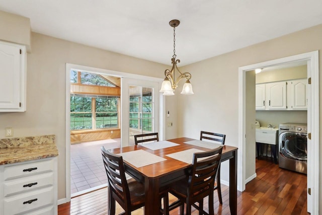 1714 Lewon Dr, Madison, WI 53711 - dining space with washer / clothes dryer, dark wood-type flooring, a chandelier, and baseboards