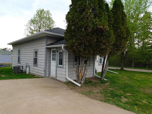 1100 Champagne St, Merrill, WI 54452 - view of side of property with a yard, central AC, and a patio area