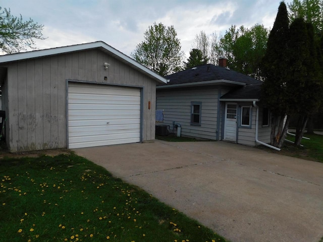 1100 Champagne St, Merrill, WI 54452 - view of front of property featuring driveway, an outbuilding, central air condition unit, and a garage