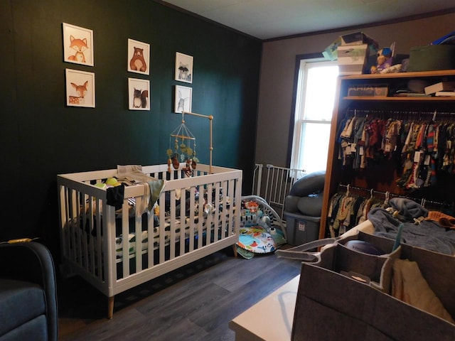 1100 Champagne St, Merrill, WI 54452 - bedroom featuring wood finished floors, crown molding, and a nursery area