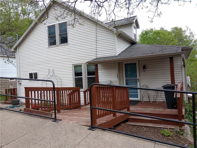 109 3rd St, Black River Falls, WI 54615 - back of house featuring a wooden deck and a shingled roof