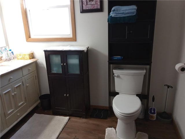 109 3rd St, Black River Falls, WI 54615 - bathroom featuring wood finished floors, toilet, vanity, and baseboards