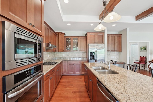 2140 Prairie View Pt, Lake Geneva, WI 53147 - kitchen featuring appliances with stainless steel finishes, a sink, brown cabinetry, glass insert cabinets, and recessed lighting