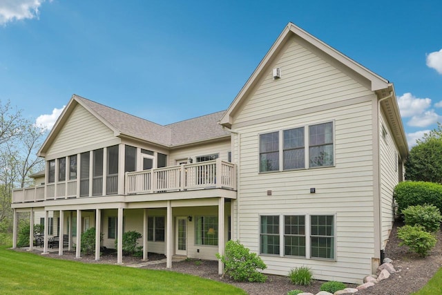2140 Prairie View Pt, Lake Geneva, WI 53147 - back of property with a sunroom, a lawn, a deck, and roof with shingles