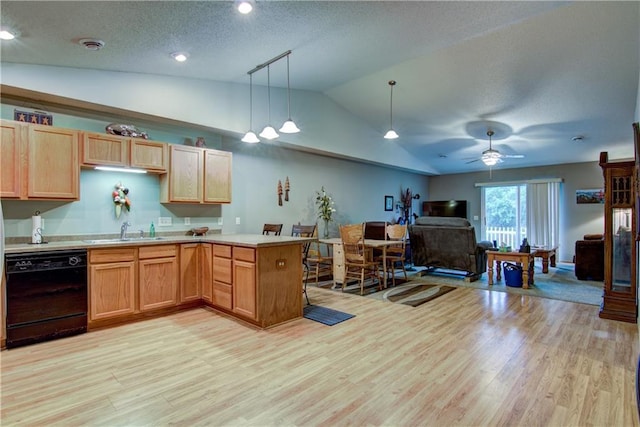13037 40th Ave Ave, Chippewa Falls, WI 54729 - kitchen with black dishwasher, vaulted ceiling, a sink, light wood-type flooring, and a peninsula
